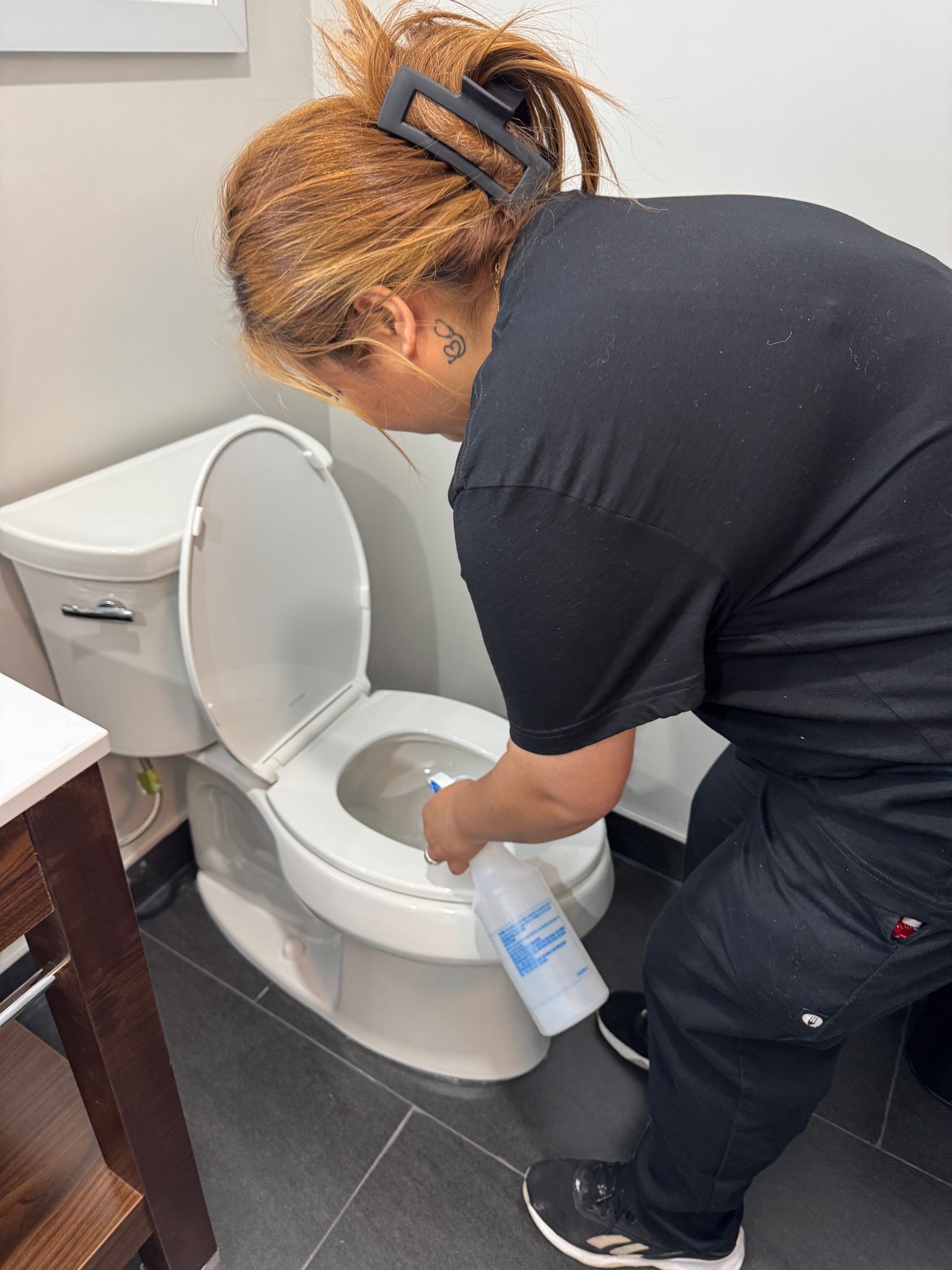 Worker sanitizing hotel bathroom