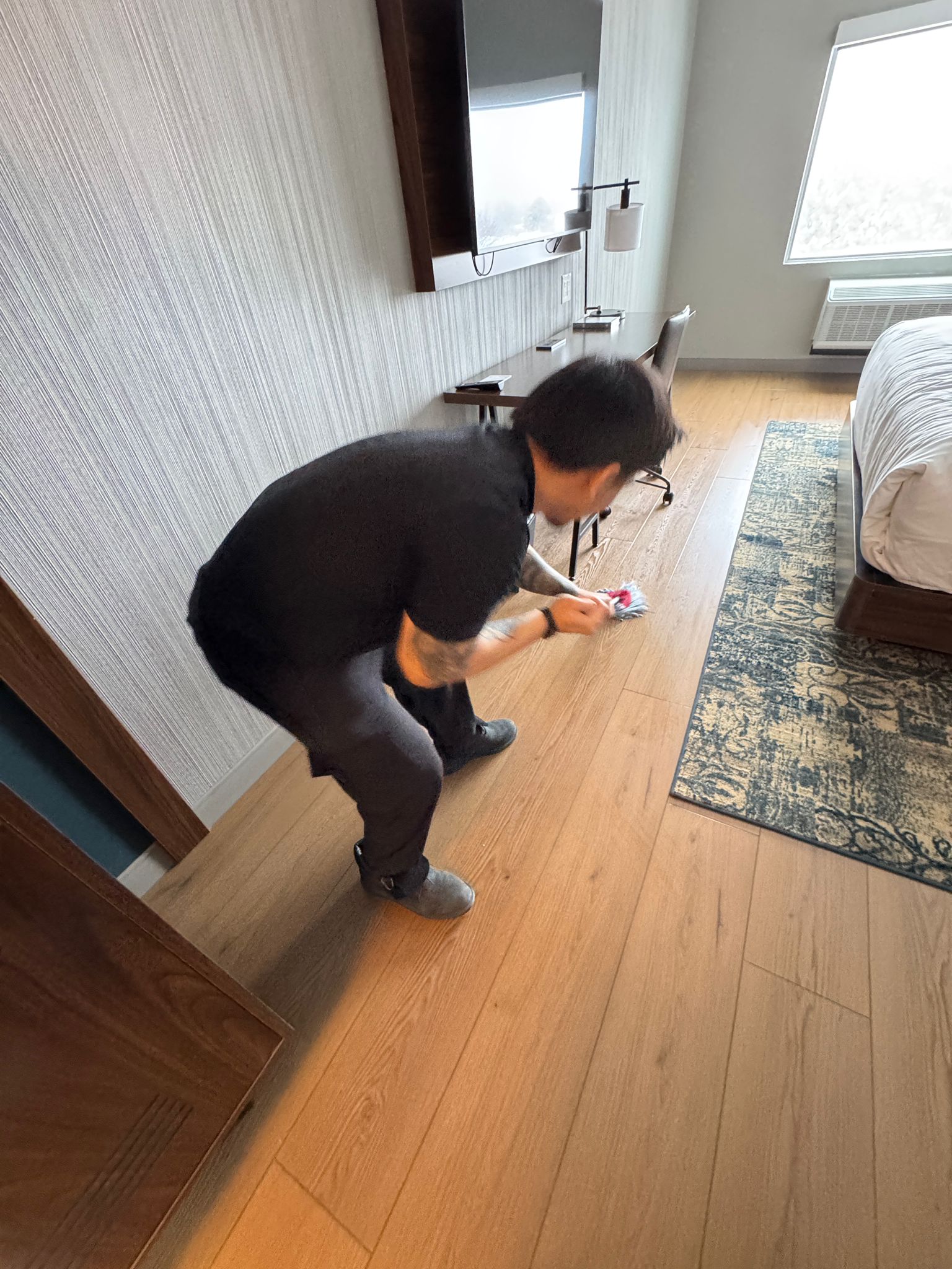 Worker detail cleaning hotel room floor