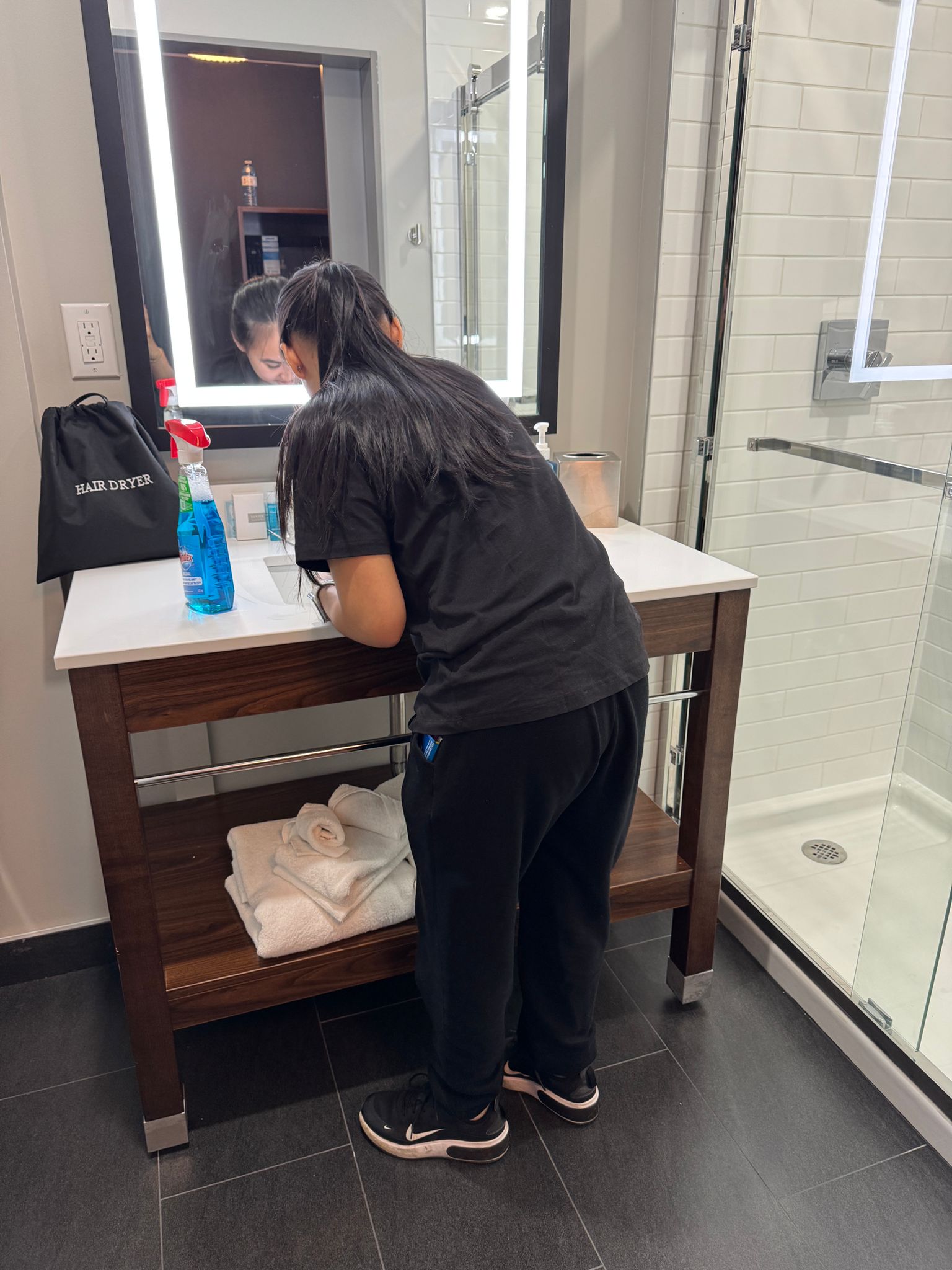 Worker cleaning bathroom vanity